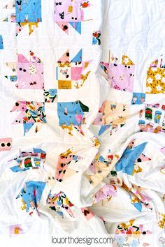 the quilt is all over the bed and it has many different designs on it's sides