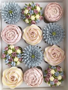 cupcakes decorated with flowers in a box