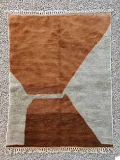 a brown and white rug on the floor