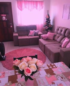 a living room filled with furniture and pink walls