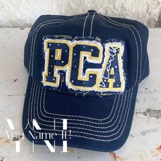 This hat features the patch on the front of the hat in a thick bold applique athletic font outlined in an accent color.   Patch on front of hat is included in price and not considered an add-on. Patches on the bill, sides and/or over the pony tail area are additional price.  You can select the option you want, if any, from the drop down below. PLEASE NOTE THE FOLLOWING IN PERSONALIZATION SECTION: 1.  Hat color (colors vary by hat style - see photos): 2.  School or team colors (primary first); 3. Athletic Fonts, Football Numbers, Block Letters, Hat Style, Block Lettering, Lettering Fonts, Team Colors, Hat Fashion, Trucker Cap