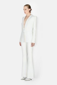 Tailor-made nuptials begin with the Sculpted Crepe blazer. Padded shoulders accentuate the hourglass shape for an empoweringly modern look. Pair with the matching trousers. Party Blazer With Structured Shoulders And Notch Lapel, Elegant Structured Fitted Pantsuit, Elegant Fitted Structured Pantsuit, Elegant Structured Pantsuit For Party, Structured Fitted Pantsuit For Party, Fitted Tuxedo-style Structured Pantsuit, Structured Tuxedo Style Fitted Pantsuit, Fitted Tuxedo Style Structured Pantsuit, Evening Suits With Structured Boning