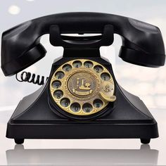 an old - fashioned rotary telephone is sitting on a table