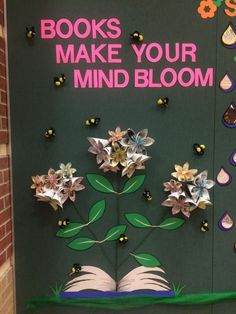 a bulletin board with books and flowers on it