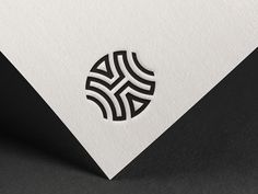 a white and black business card with an abstract design on it's front side