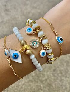 Gorgeous White and Gold Evil Eye bracelet set. This set comes with 4 bracelets exactly as pictured! The bracelets are made with Czech beads, evil Eye charms, gold spacer beads and stainless steel chain.  Perfect for protection and fashion. Spiritual White Beaded Bracelets With Evil Eye, Spiritual White Evil Eye Bracelets, Bracelets Evil Eye, Eye Bracelets, Bracelet Sets, White Bracelets, Gold Bracelets, Protection Bracelet, Star Bracelet