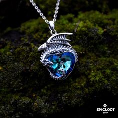 The dragon is a powerful symbol that has been revered for centuries in many cultures. It represents strength, courage, and protection. This beautiful blue crystal heart necklace is the perfect way to show your inner strength and remind you of the powerful, protective energy that all of us have inside. Whether you're dressing up or just want to add a little bit of magic to your everyday look, this necklace is sure to inspire your confidence and make you feel beautiful every time you wear it. Trea Mystical Blue Pendant Necklace, Magical Blue Pendant Jewelry, Blue Fantasy Jewelry For Gifts, Blue Fantasy Jewelry For Gift, Blue Spiritual Heart Pendant Jewelry, Spiritual Blue Heart Pendant Jewelry, Spiritual Blue Heart Pendant Necklace, Mystical Blue Sterling Silver Necklace, Dragon Jewelry Necklace