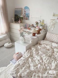 a bedroom with white furniture and pink flowers