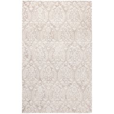 a white rug with an intricate design on the front and back side, in shades of beige