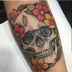 a skull with flowers on it's arm