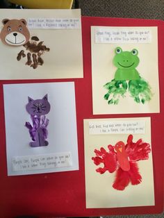 four different handprints are displayed on a bulletin board with pictures of animals and plants