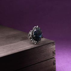 This gorgeous sterling silver ring is perfect for a person with a flare for vintage jewelry. The Blue Sapphire Peacock Vintage Ring features an oval blue sapphire as its centerpiece, encircled by small round white diamonds that catch the light gloriously and radiate life! From cornflower blue to velvety blue, there are multifarious shades of blue sapphire that gives it a silky tint. Characterized by the power of Shani or Saturn, Blue Sapphire displays violet to indigo and pale blue as well as da Puka Shell, Royal Blue Color, Cornflower Blue, Vintage Ring, Well Being, Estate Jewelry, Diamond White, Shades Of Blue, Beautiful Rings