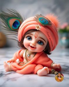 a small doll is dressed in an orange outfit with feathers on it's head