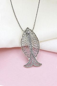 Our product is made of 925 sterling silver. It is embroidered with filigree art. All of our product is handcrafted. The average weight of the necklace (including the chain) is 6 grams. Pendant length: 4.6 cm, width: 2.2 cm. 45 cm long, 1 mm thick silver chain is sent with the product. Handmade Silver Fish-shaped Necklace, Holy Symbol, Fish Animal, Fish Model, Handcrafted Silver Jewelry, Animal Necklace, Fish Necklace, Fish Pendant, Animal Pendant