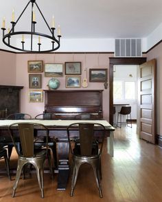 a dining room table with chairs and a piano