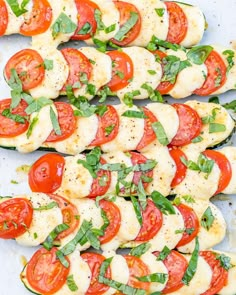 sliced tomatoes and mozzarella with basil on top