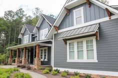 a gray house with white trim and windows