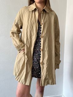 Unlined lightweight raglan sleeve button up trench coat with epaulettes on the sleeve cuffs. Includes pockets. In excellent vintage condition. DETAILSLabel: Max StudioMaterial: 55% Cotton, 39% Nylon, 6% Metal SIZE & MEASUREMENTSTag Size: MediumLength: 34"Bust: 40"Waist: 44"Hips: 52"Sleeve: 26"Shoulder: 18" Vintage Outerwear With Buttoned Pockets And Long Sleeves, Vintage Outerwear With Buttoned Pockets For Work, Vintage Outerwear For Spring, Vintage Long Sleeve Outerwear With Buttoned Pockets, Solid Buttoned Outerwear For Daywear, Vintage Outerwear With Buttoned Pockets And Lapel Collar, Vintage Oversized Outerwear For Everyday, Spring Vintage Outerwear With Buttoned Pockets, Vintage Collared Outerwear With Buttoned Pockets