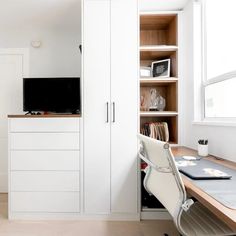 a desk and chair in a small room