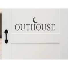 a door with the word outhouse painted on it