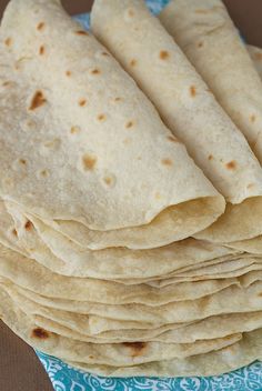 a stack of tortillas sitting on top of a blue cloth