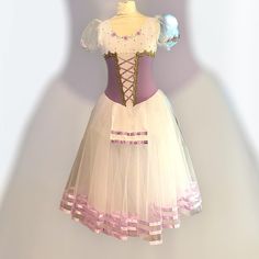 a dress made out of tulle and fabric with laces on the bottom, in front of a white background