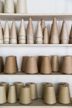 many spools of thread are sitting on shelves