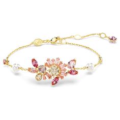 Mirroring the exquisite petals of Japan’s cherry blossom flower, this Gema bracelet is vividly captivating. Fastened with a lobster closure, the gold-tone plated jewelry is worn on a delicate chain with scattered Crystal Pearls and crystals. At the center, it features a diverse mix of fancy cut crystals and Swarovski Zirconia in vibrant shades of pink and champagne. Wear this bracelet alone to embrace nature-infused wonder, or pair with a matching piece from our Gema Sakura jewelry family. Pink Flower Bracelet, Pink And Champagne, Pink Watch, Swarovski Bracelet, Rose Gold Watches, Jewelry Lookbook, Delicate Chain, Swarovski Jewelry, Flower Bracelet