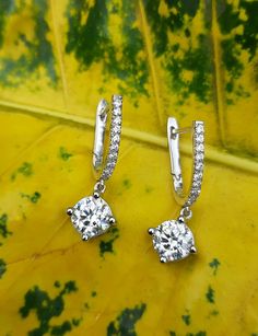 2.0Ct Round Cut Moissanite Hoop Earrings Women Wedding earring Dangle & Drop Earring 14k White Gold Anniversary Gift Birthday Gift Mom Gift.  🖤 Item Information ◆ Metal:  14k White Gold ◆ Ring Size: 4 to 12 USA All Size available ◆ Main Stone:  6mm Round Cut Moissanite ◆ Side Stone: 1.2mm Round Cut Simulated Diamond ◆ Moissanite Color: DEF Near Colorless ◆ Main Stone Creation: Lab-Created ◆ Stone Clarity: VVS1 ◆ Setting: Prong Setting ◆ Style: Hoop  ◆ Cut: Excellent ◆ Polish: Excellent ◆ Center Gift Hoop Earrings With Halo Design And Round Cut, Halo Design Hoop Earrings Gift, Hoop Earrings With Halo Design For Gift, Gift Hoop Earrings With Halo Design, Dangle Hoop Earrings With Halo Design In Cubic Zirconia, Diamond White Hoop Earrings With Prong Setting As Gift, Prong Setting Drop Huggie Earrings For Wedding, Wedding Dangle Hoop Earrings Diamond Cut, White Gold Dangle Hoop Earrings For Anniversary