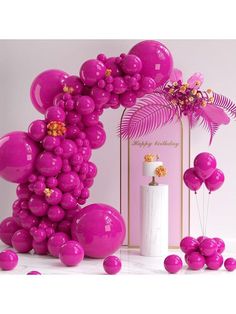 the balloon arch is decorated with pink balloons