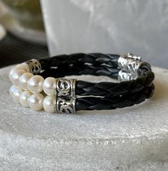 Beautiful Braided Black Leather Sterling Silver Natural Pearl Vintage Bracelet See pictures next to ruler for scale See link below for matching necklace https://www.etsy.com/listing/981075566/beautiful-braided-black-leather-sterling?ref=shop_home_active_1&frs=1 Elegant Double Band Leather Bracelet As Gift, Handmade Elegant Leather Bracelet, Elegant Handmade Leather Bracelet, Elegant Handmade Black Wrap Bracelet, Elegant Round Adjustable Leather Bracelet, Elegant Handmade Adjustable Leather Bracelet, Elegant Adjustable Leather Bracelet For Anniversary, Elegant Handmade Black Leather Bracelet, Elegant Handmade Double Band Jewelry