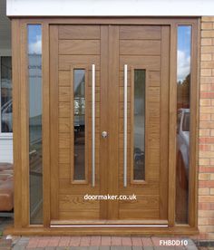 a wooden door with glass panels and sidelights on the front of a brick building