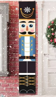 a christmas door hanger with a nutcracker in front of a brick wall