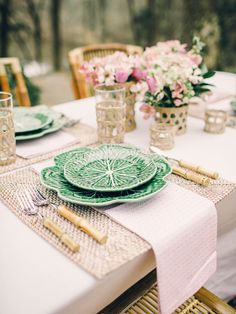 the table is set with plates and silverware