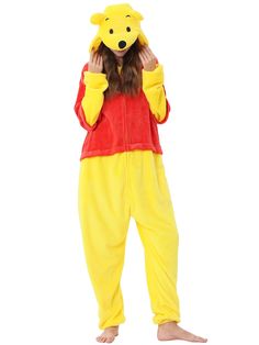 a person in a winnie the pooh costume is holding his head to his ears