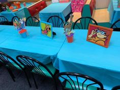 there are many tables and chairs with blue tablecloths