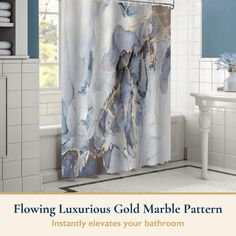 a bathroom with blue and white marble shower curtain, toilet paper roll and bathtub