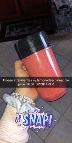 a person holding a drink in their hand with the caption frozen strawberries lemonade pineapple juice best drink ever