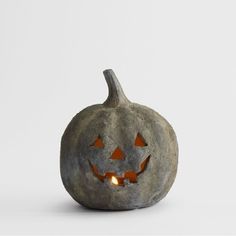 a pumpkin shaped candle holder with glowing eyes