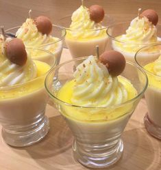 several desserts in small glass dishes on a table