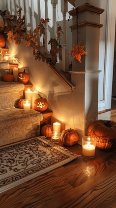 pumpkins and candles on the stairs in an old house