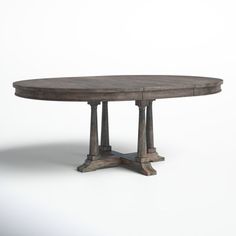 an oval wooden table with four pillars on each end