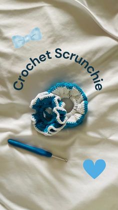 crochet scrunchies are laying on a blanket next to a knitting needle