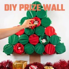 a christmas tree made out of paper plates and other holiday decorations, with the words diy prize wall above it