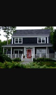 a white house with a red door and porch