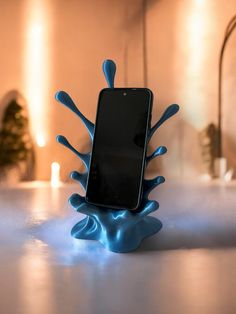 a cell phone sitting on top of a blue liquid filled stand in front of a mirror