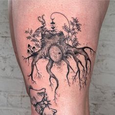 a black and white tattoo on the leg of a woman with an octopus in it