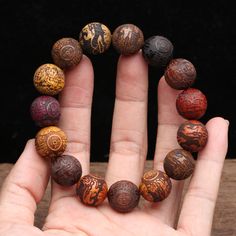 Choose from a variety of different woods for your Lucky Pixiu Good Karma Bracelet  These wooden beads are engraved with the mythical beast, the PIXIU, from natural, unstained wood. The Pixiu symbolizes good fortune, and protection.    These bracelets are made up in a variety of different woods including ebony, white wood, violet wood, golden wood,wenge wood, nanmu wood, Zambian rosewood and gold silk wood.     Or if you prefer, you can have a mixture of different wood beads in one bracelet.   Choose from either 15mm beads (total of 15 beads/bracelet) for women or 20 mm ( total of 12 beads/bracelet ), more suited for men.    Want to know more about the Feng Shui Pixiu?     The Pi Xiu is a legendary auspicious creature and is known for wealth attraction and is one of the five auspicious anim Inner Energy, Karma Bracelet, Buddhist Bracelet, Wenge Wood, Wooden Bracelet, Gold Silk, Fashion Materials, Hair Beads, Halloween Accessories