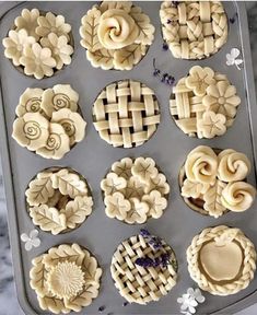 twelve pies are arranged on a baking sheet and ready to go into the oven