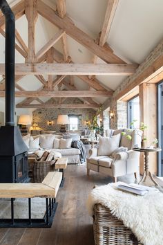 a living room filled with furniture and a fire place in the middle of a room